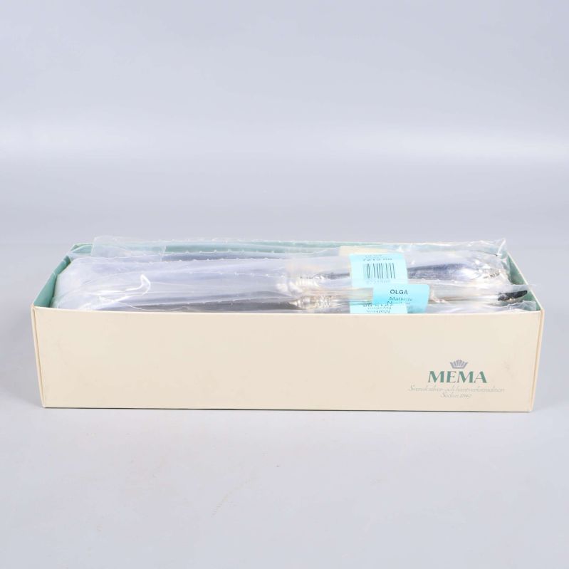 Stängd ljusgul kartong märkt MEMA för bestickset