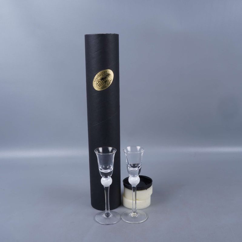 Två snapsglas framför en svart förvaringslåda