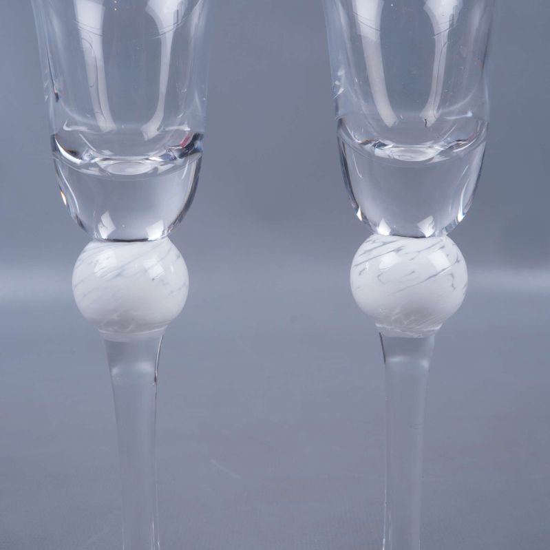 Närbild på vit dekorboll mitt på snapsglasens stjälkar