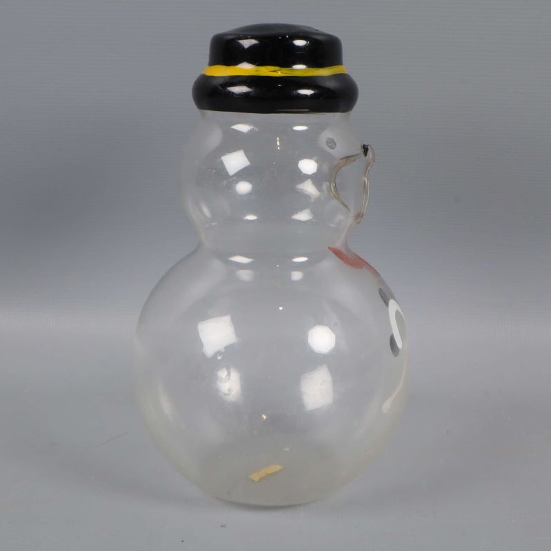 Snögubbe i glas sedd från vänster sida