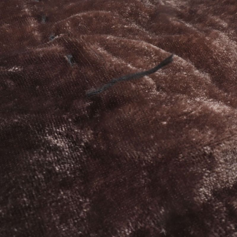 Närbild av sammetsyta med lös tråd