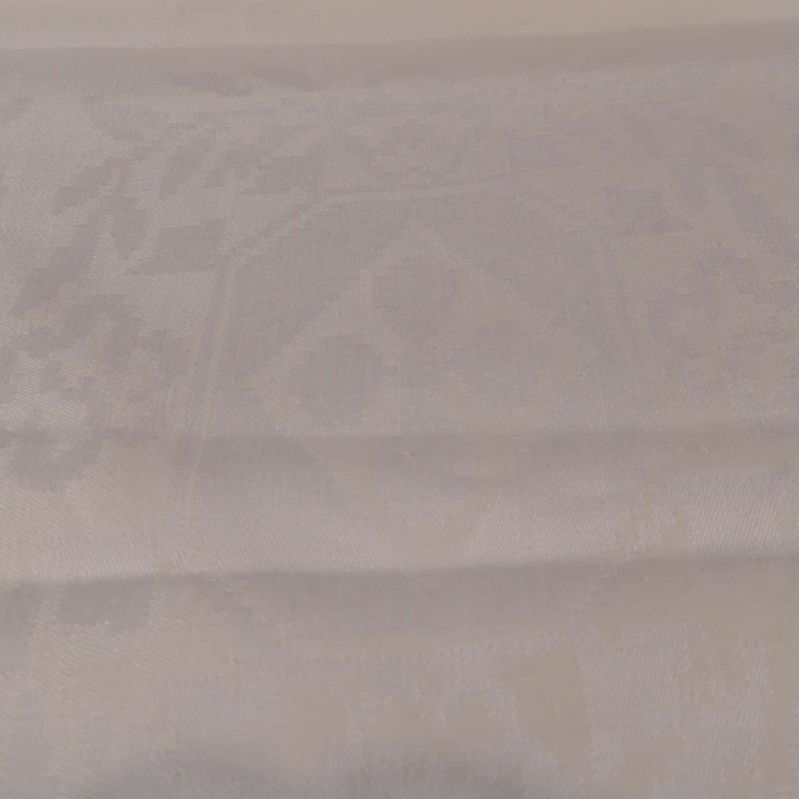 Närbild på vävd design i ljus textilduk