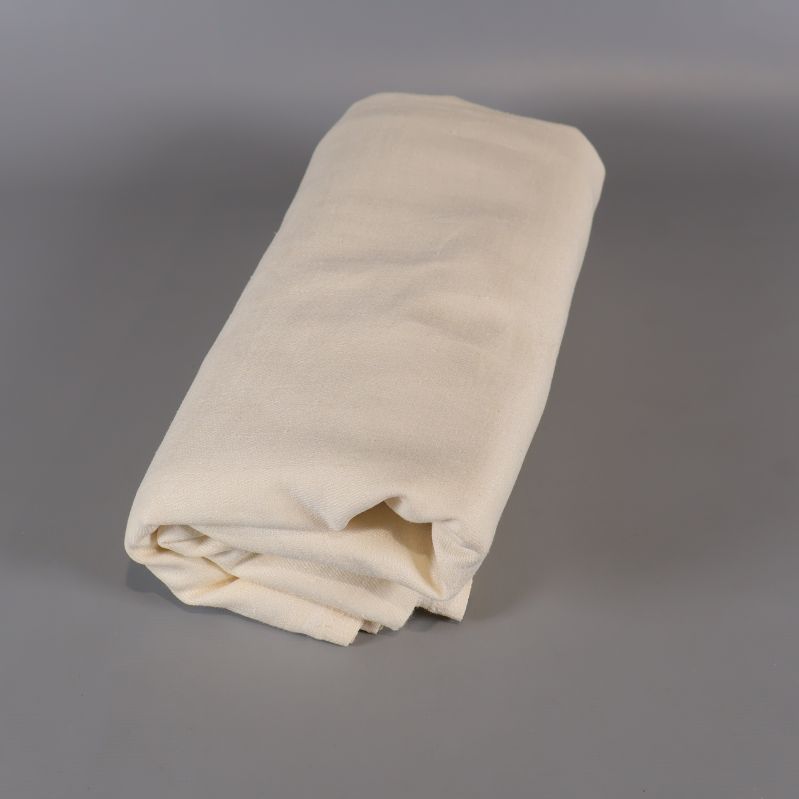 Ljus duk rullad till ett kompakt paket