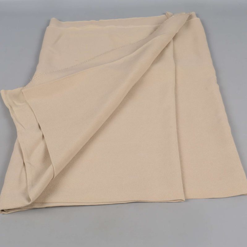 Uppvikt beige tyg som visar framsida och baksida