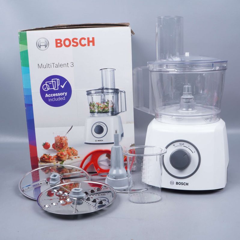 Matberedare med tillbehör framför originalförpackning från Bosch