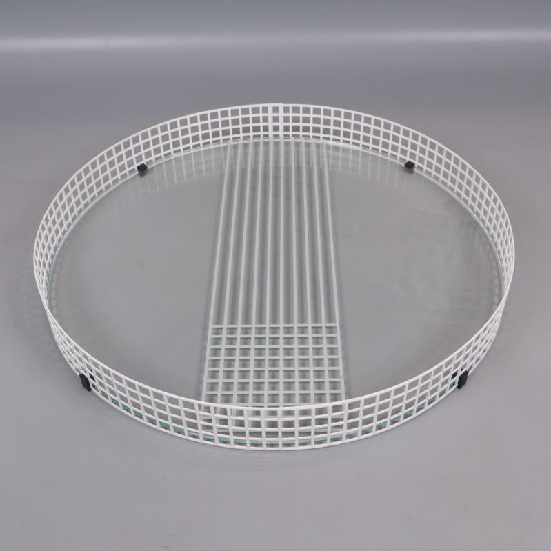 Rund bricka med glasbotten och vit metallram