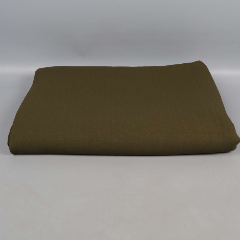 Snyggt vikt militärgrönt vintage tyg mot grå bakgrund