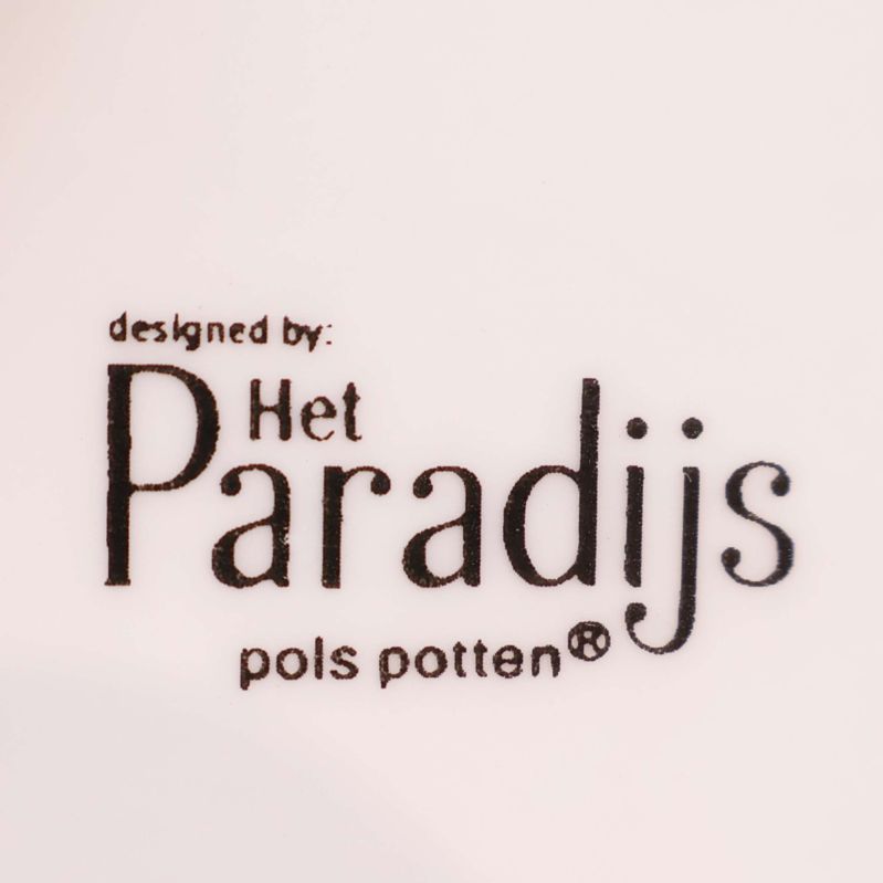 Närbild av märkning Het Paradijs pols potten på porslin