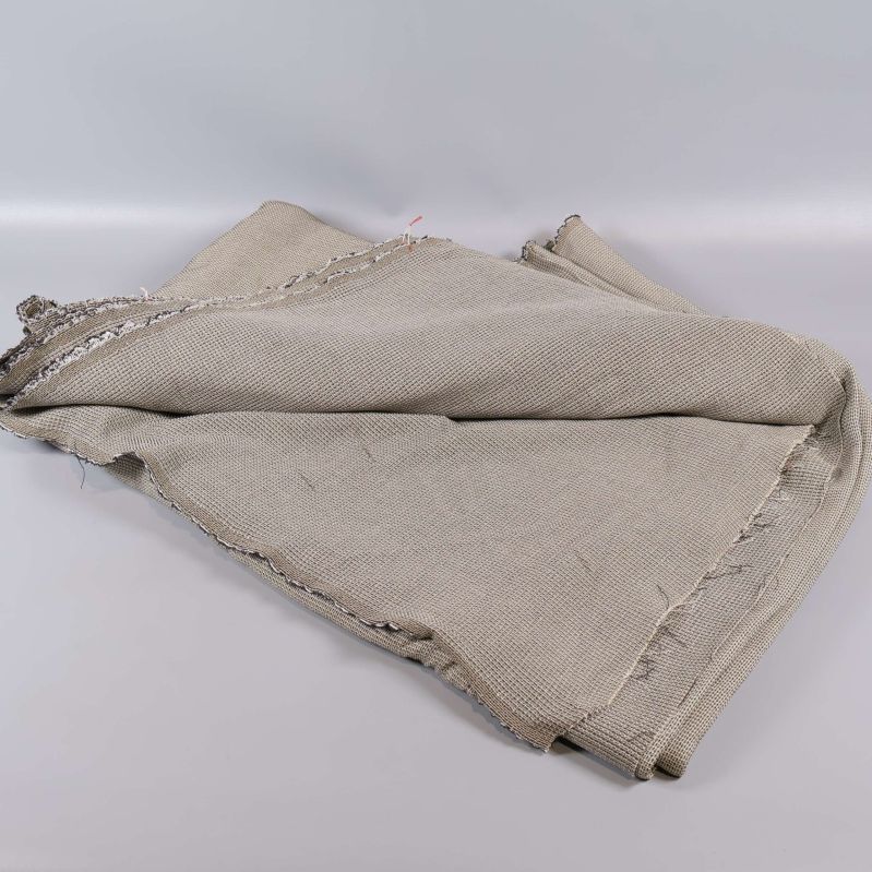 Utbredd beige textil med våfflad yta