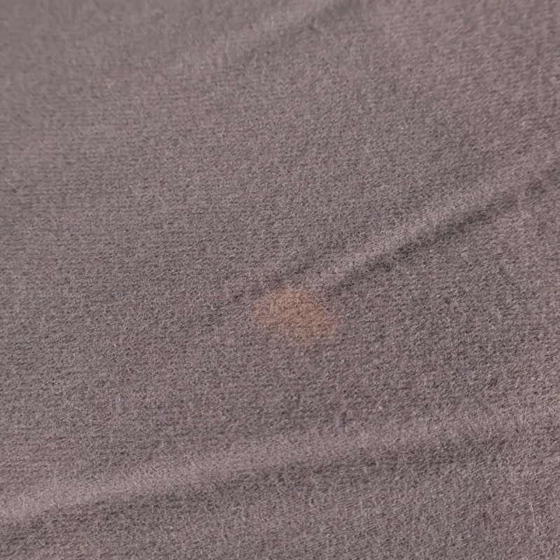 Detalj på tyg med mindre fläck