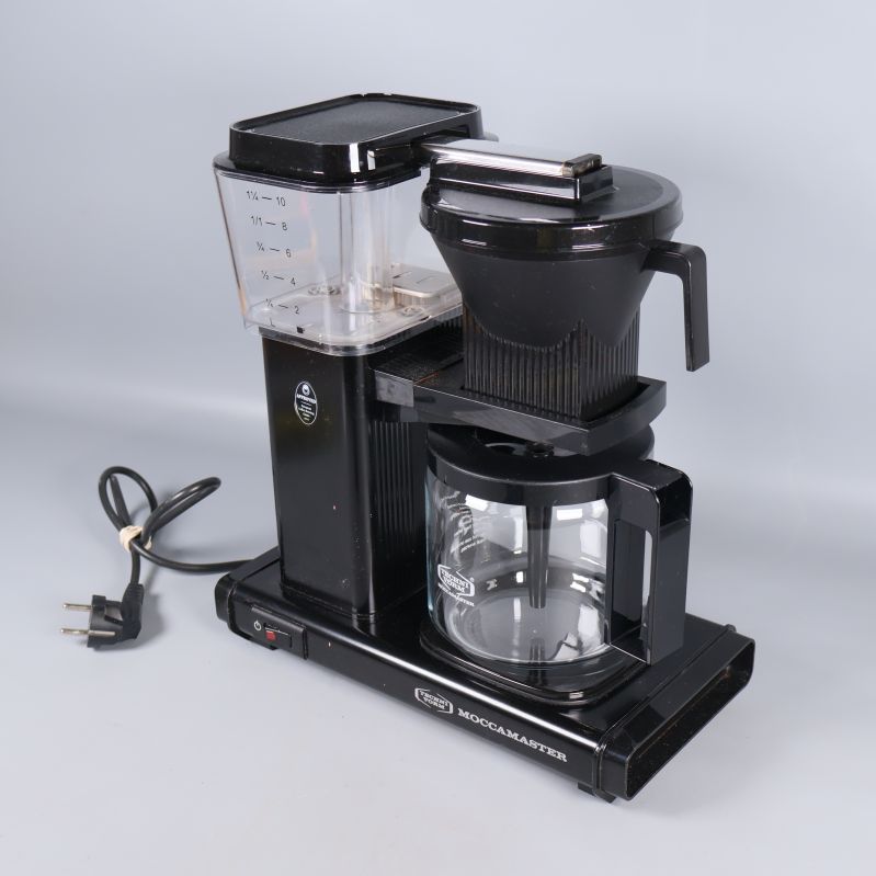 Kaffebryggare i svart plast och glas, elsladd synlig