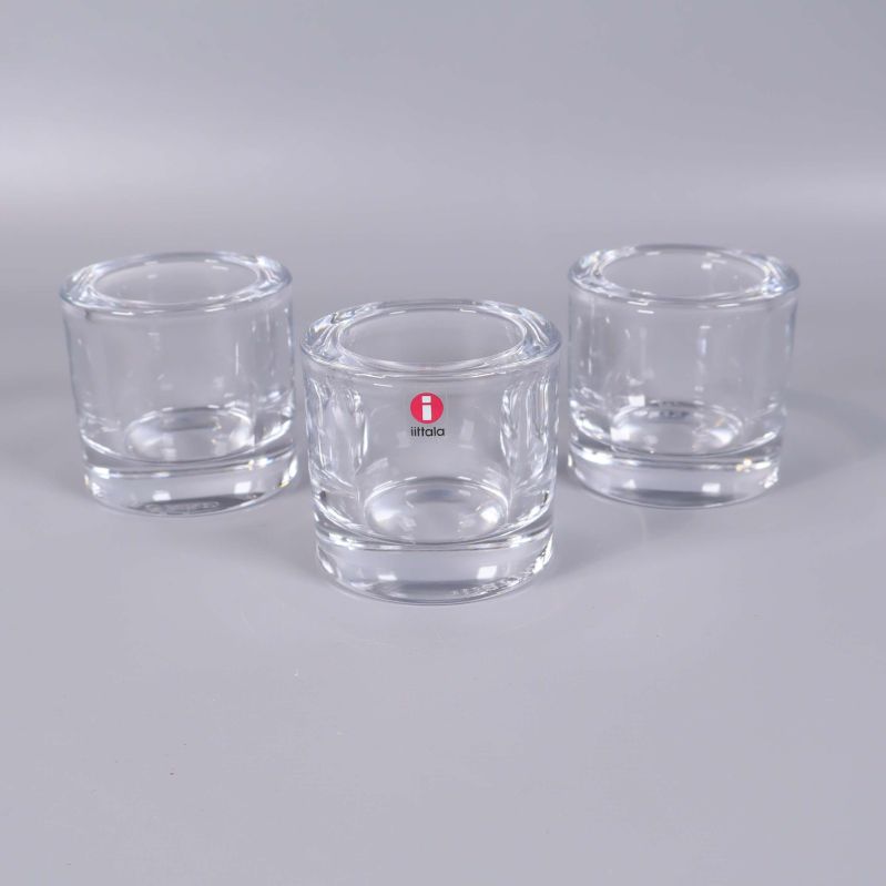 Tre cylinderformade ljushållare i klart glas, en med Iittala-märke