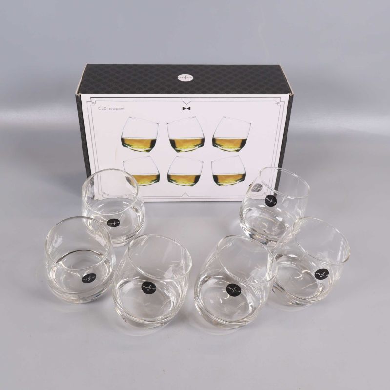 Sex snedställda whiskyglas framför en förpackning