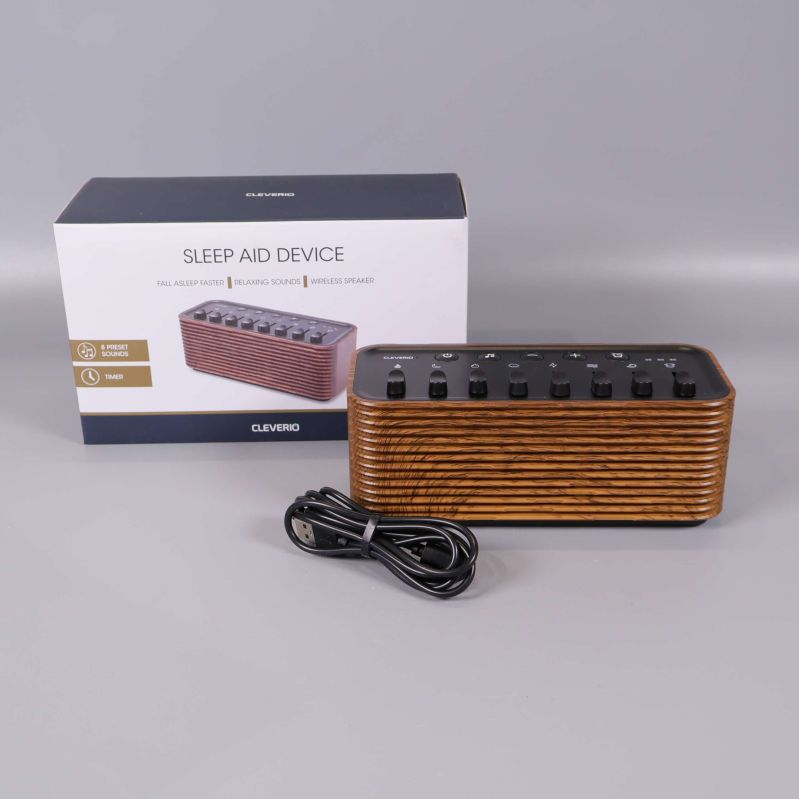 Sleep aid-enhet med låda och USB-kabel på grå bakgrund