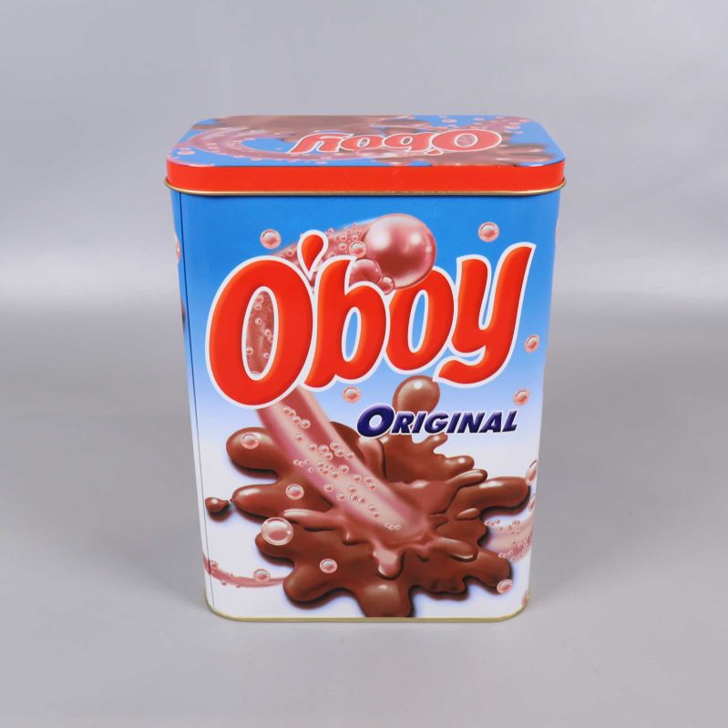 Andra sida av O'boy plåtburk med stort motiv och blå bakgrund