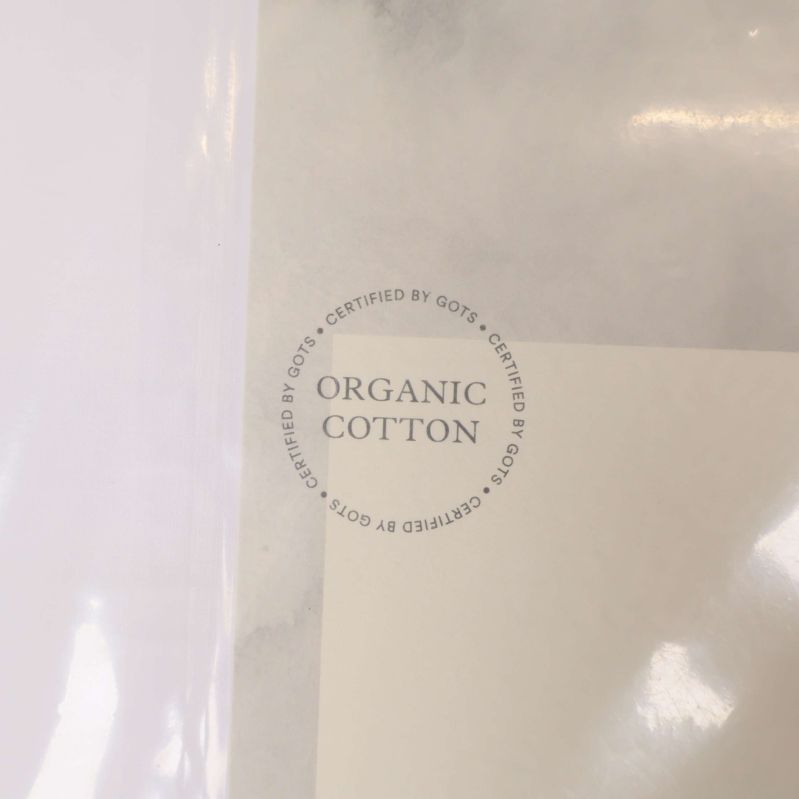 Rund stämpel med texten Organic Cotton på etiketten