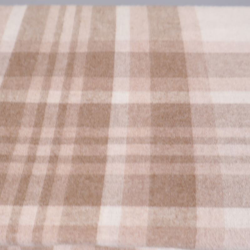 Närbild på det beige och bruna rutmönstret i flanelltyget