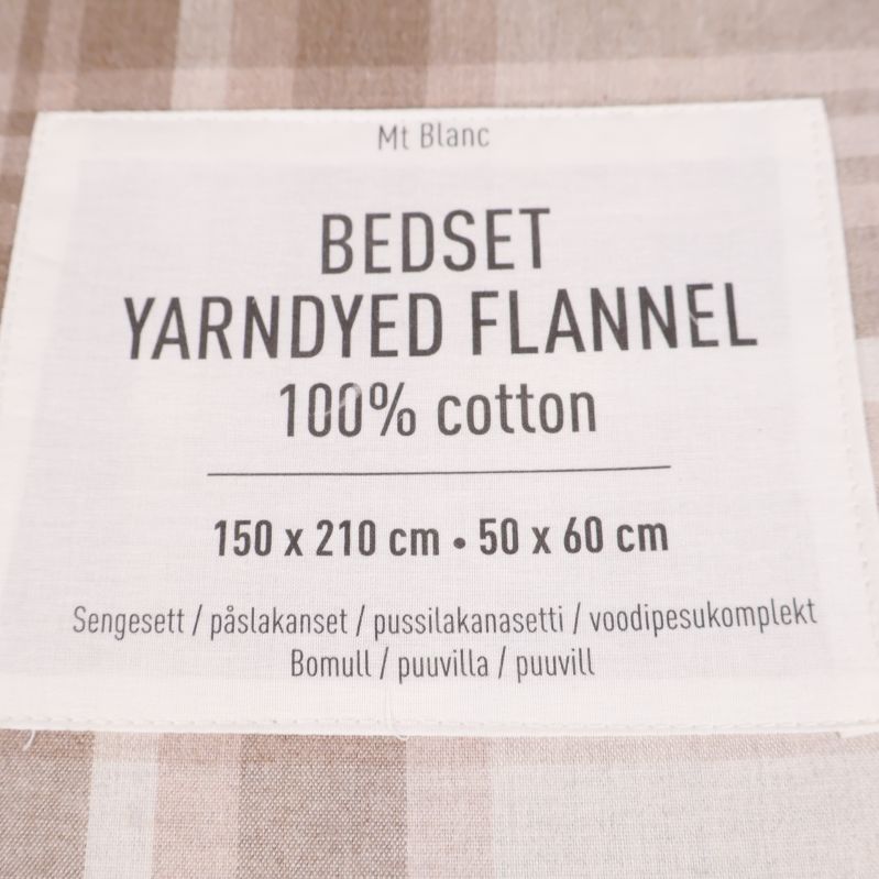 Etikett på påslakanset som visar 100% bomull och storlek