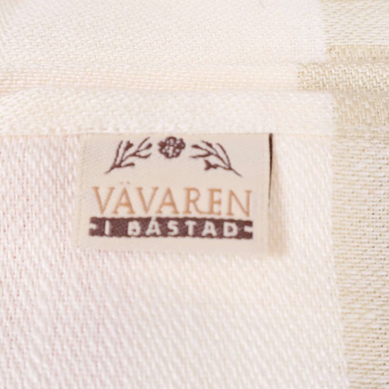 Etikett från Vävaren i Båstad på linnelöparen