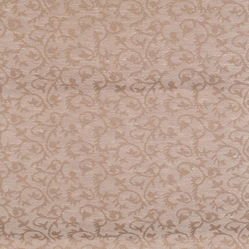 Detaljbild av mönstrad textil i beige nyanser