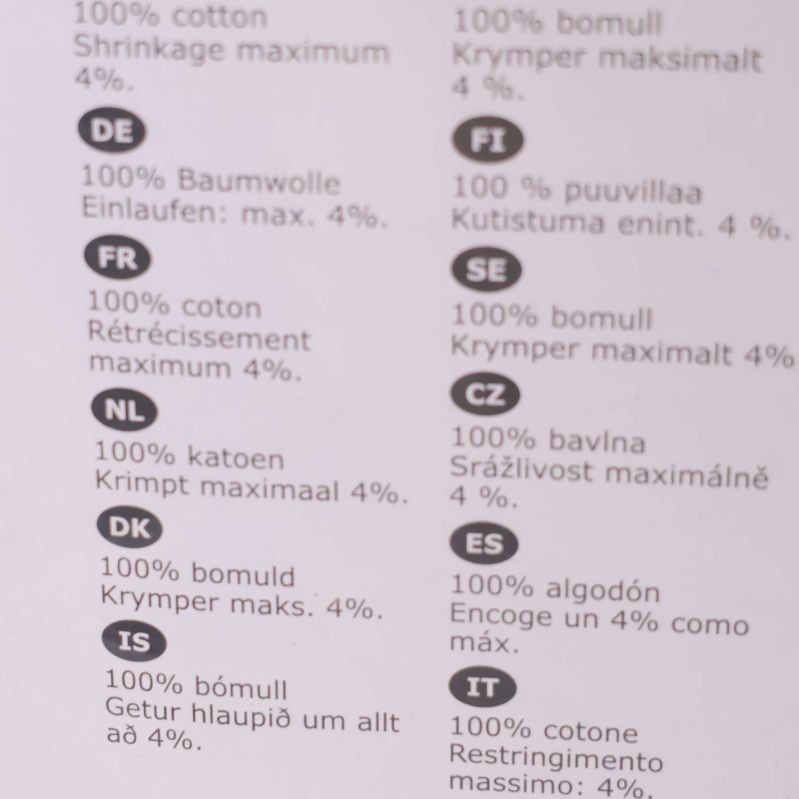 Materialinformation visar 100 procent bomull på flera språk
