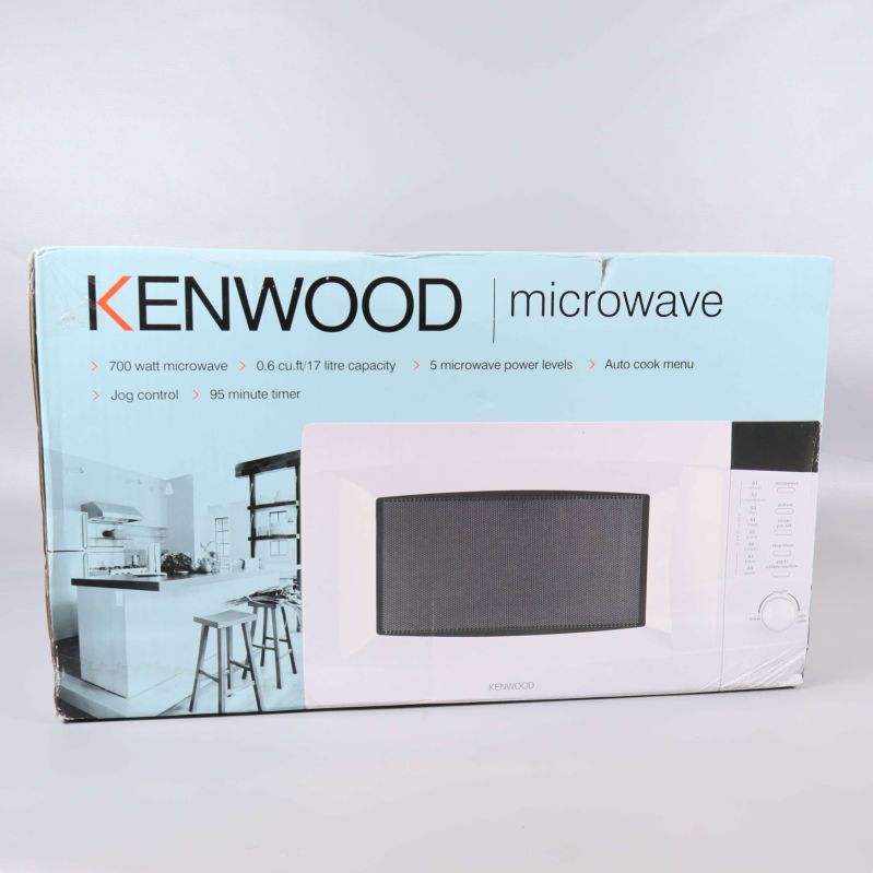 Kenwood mikrovågsugn i kartong sedd framifrån