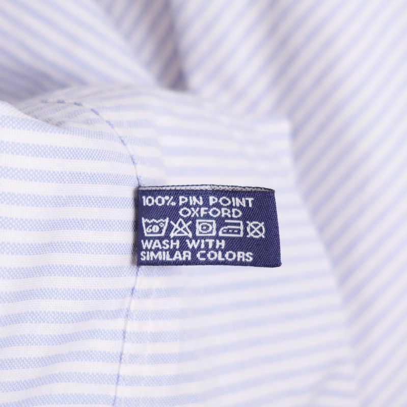 Tvättlapp med text 100% pin point oxford
