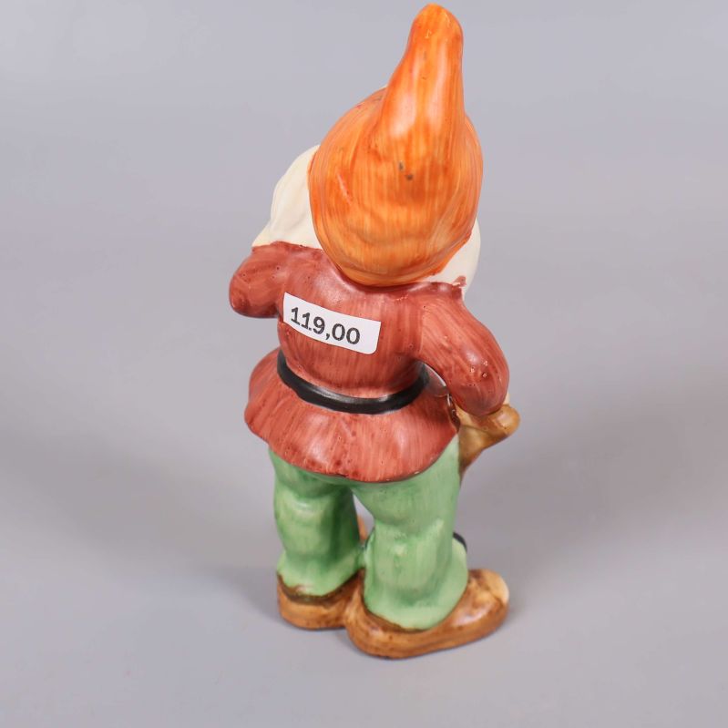 Tomtefigur bakifrån med orange luva och röd jacka