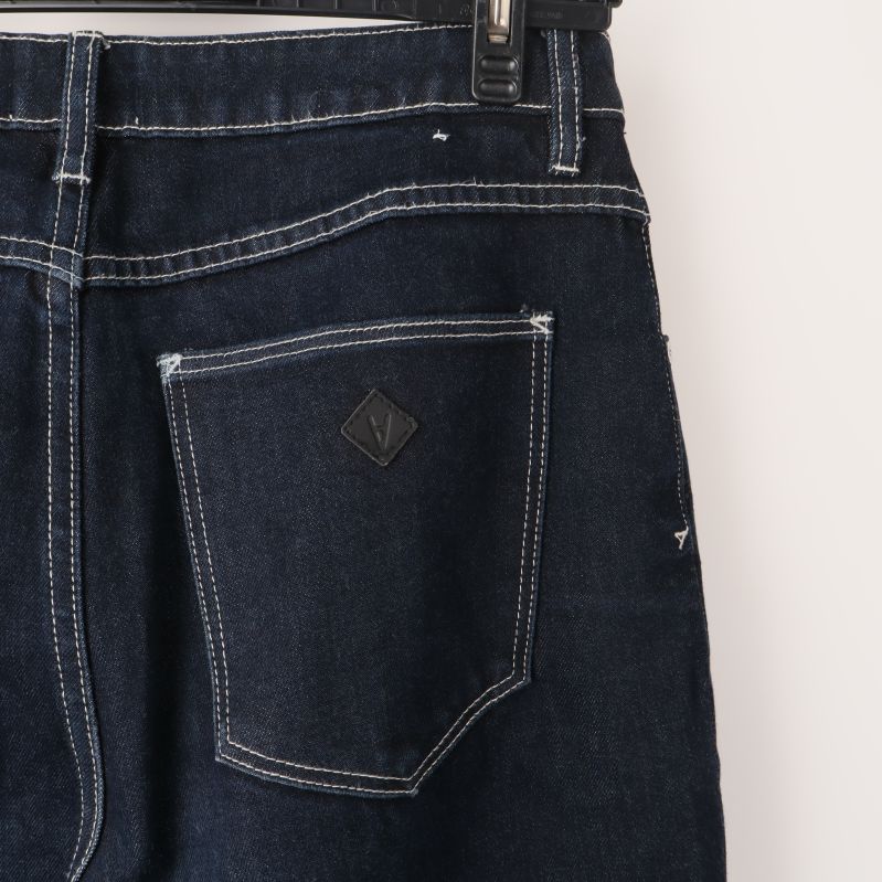 Bakficka av mörka jeans med etikett