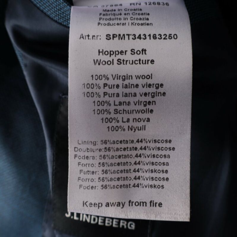 Materialetikett som visar på 100% virgin wool