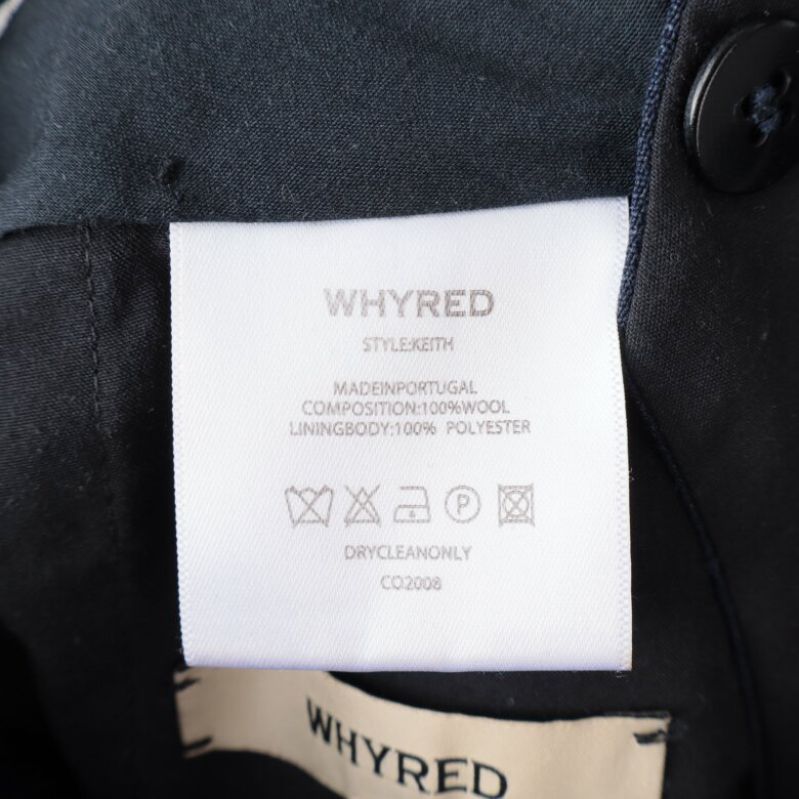Materialetikett för kostymbyxorna visar ull och polyester
