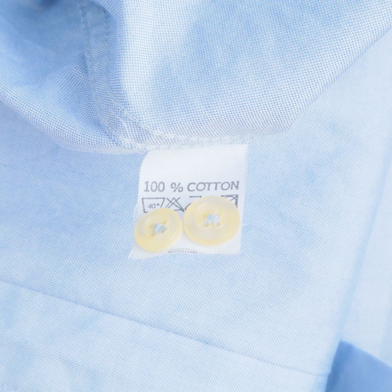 Materialetikett som visar: 100% bomull
