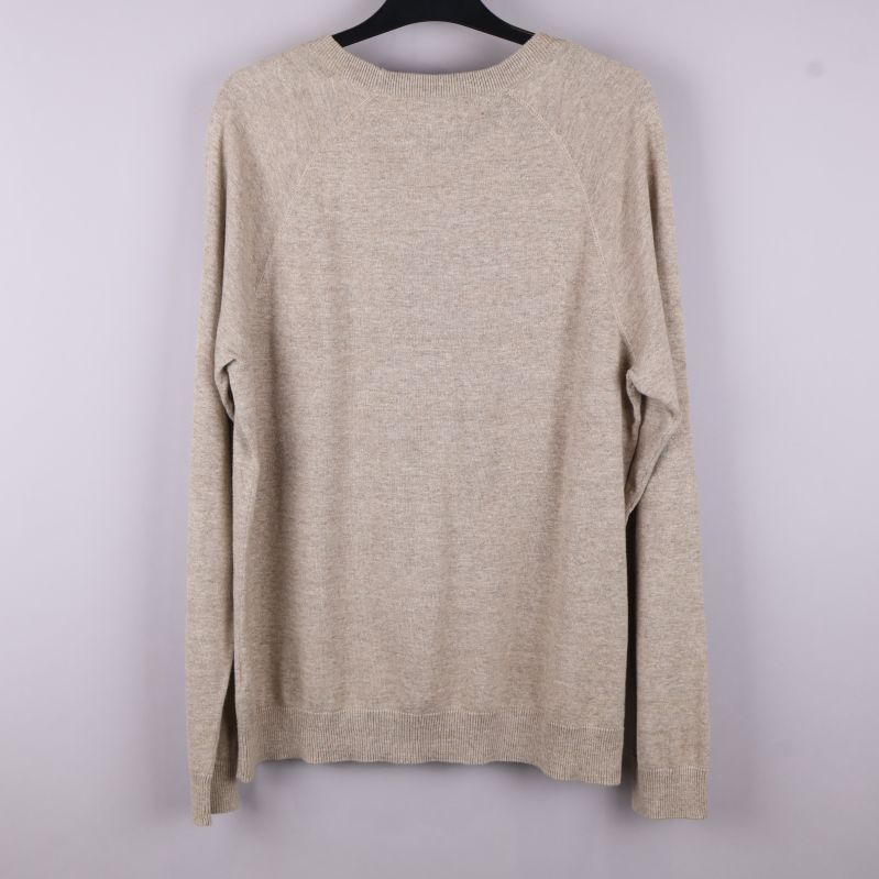 Baksidan av beige stickad tröja