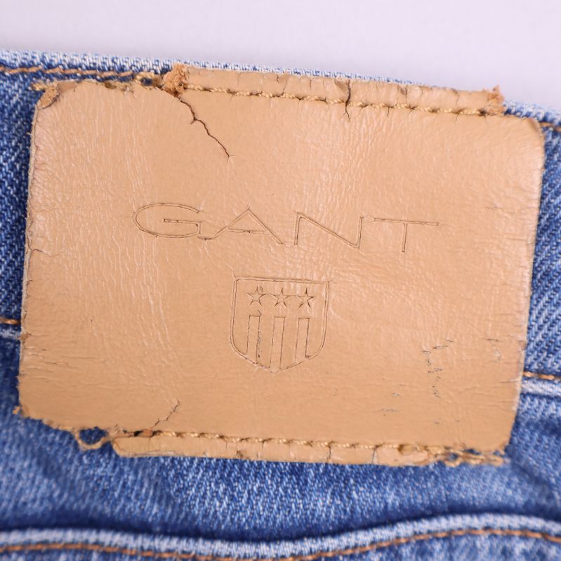 Gant-logotyp på en läderlapp fäst bakpå jeans