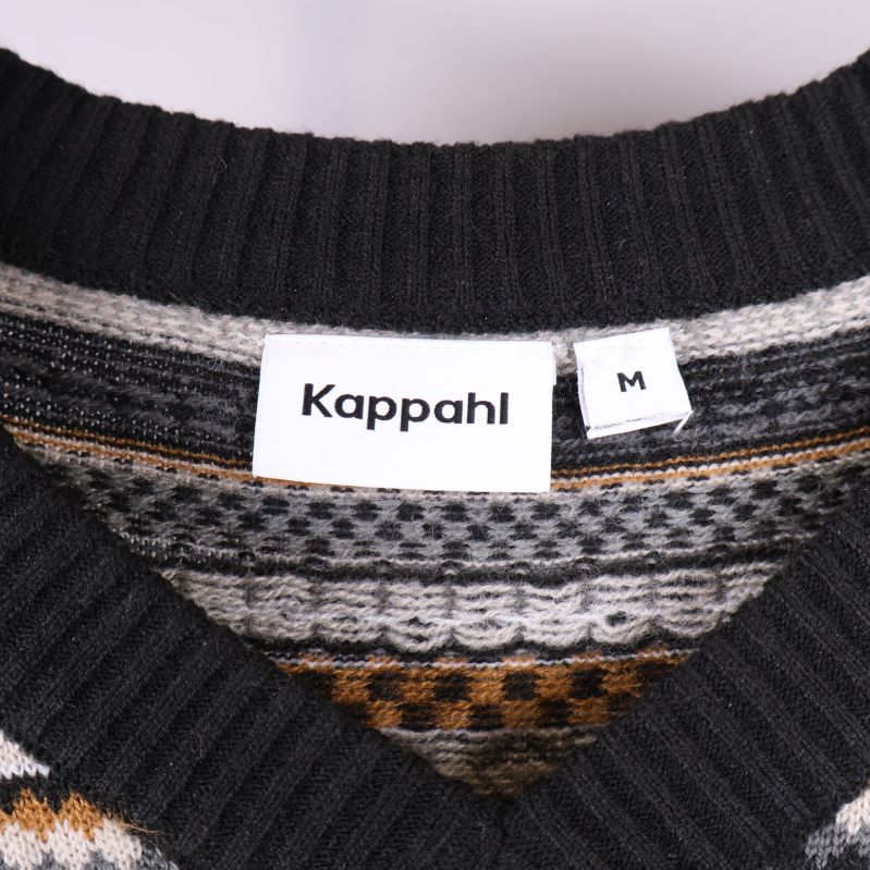 Kappahl etikett synlig på väst
