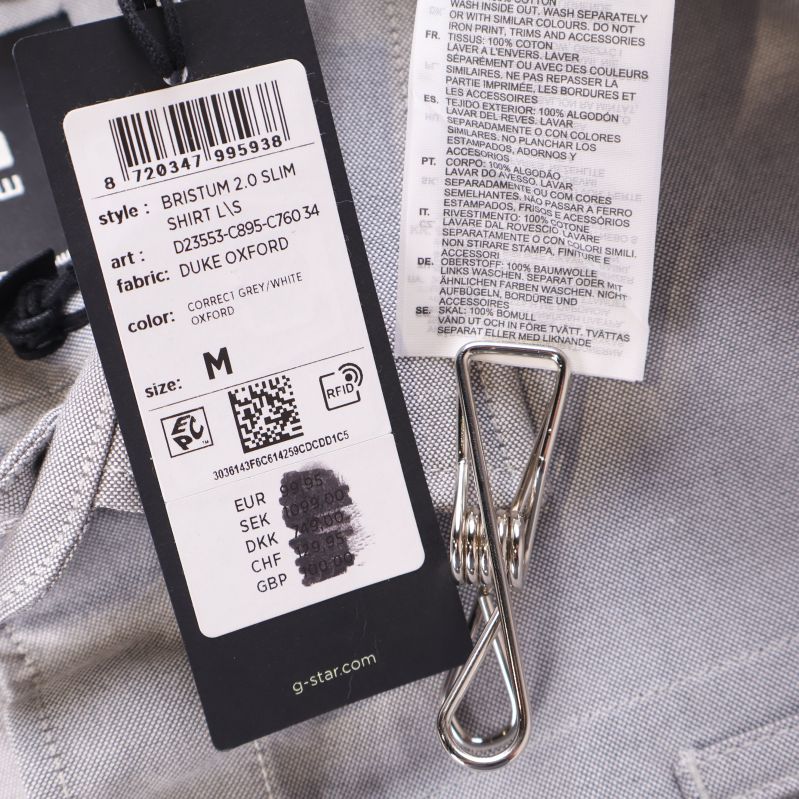Tag med tillverkarinformation och materialetikett