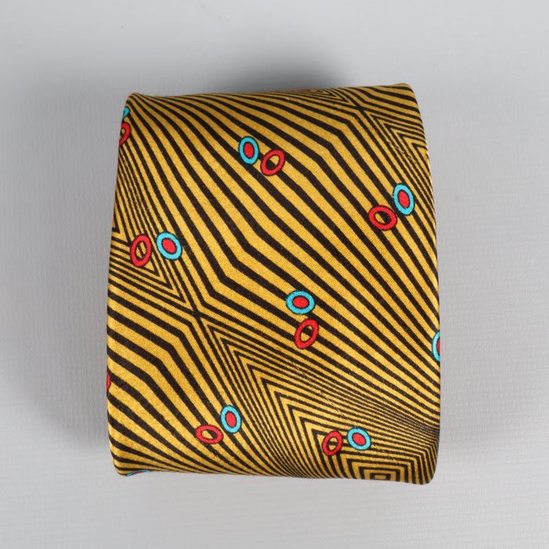 Bred spets på slips med grafiskt mönster och små cirklar