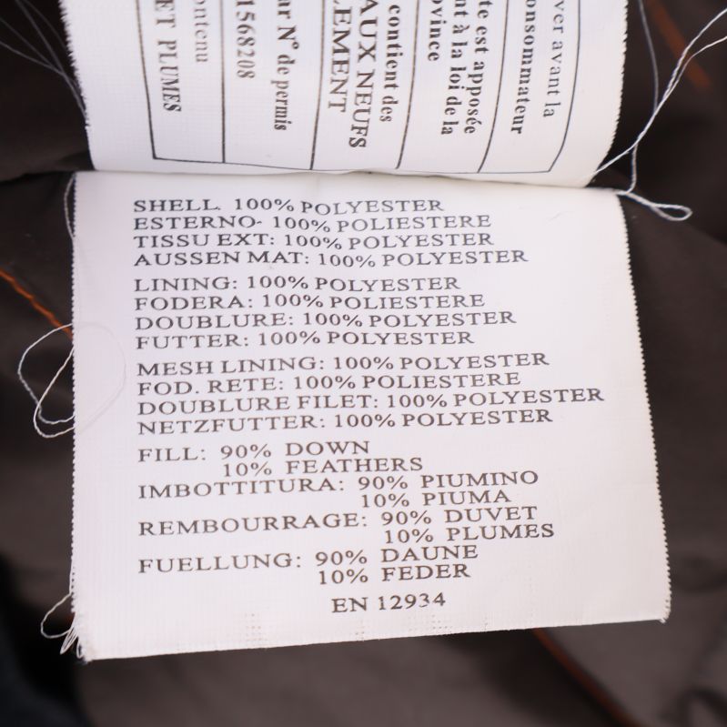 Materialetikett som anger polyester, dun och fjäder