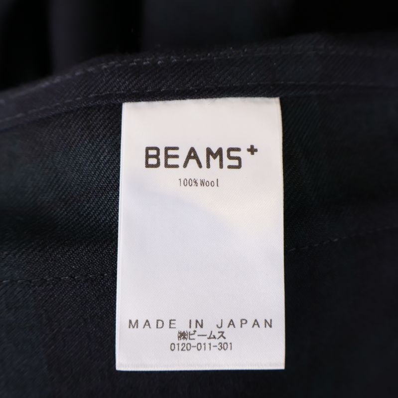 Materiallapp som visar 100% ull och Made in Japan