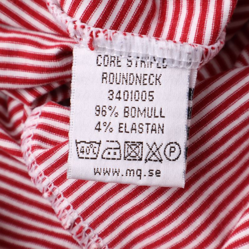 Materiallapp med text: 96% bomull, 4% elastan