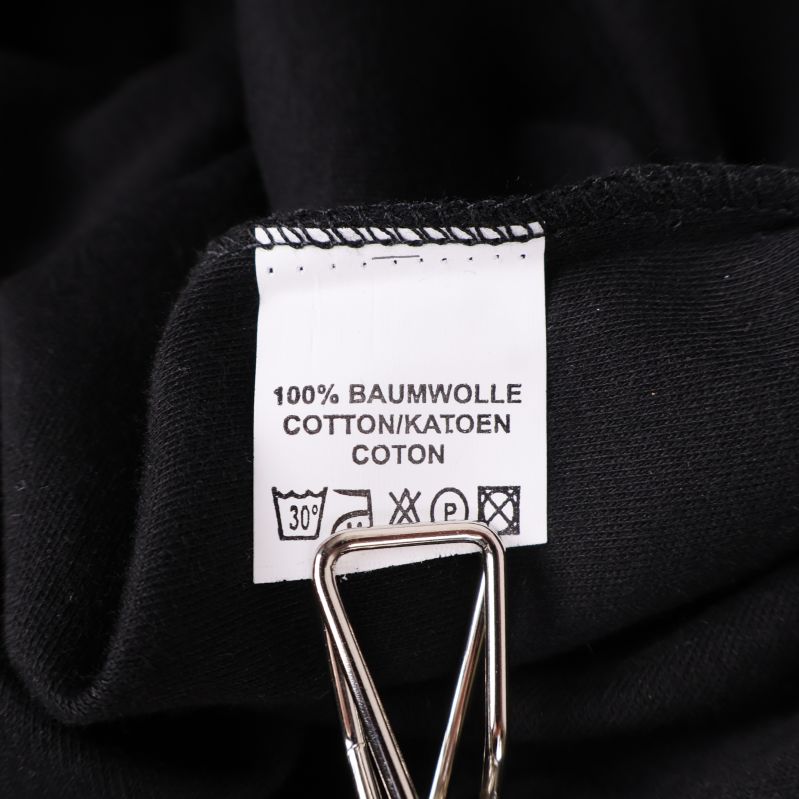 Materiallapp med text 100% bomull på flera språk
