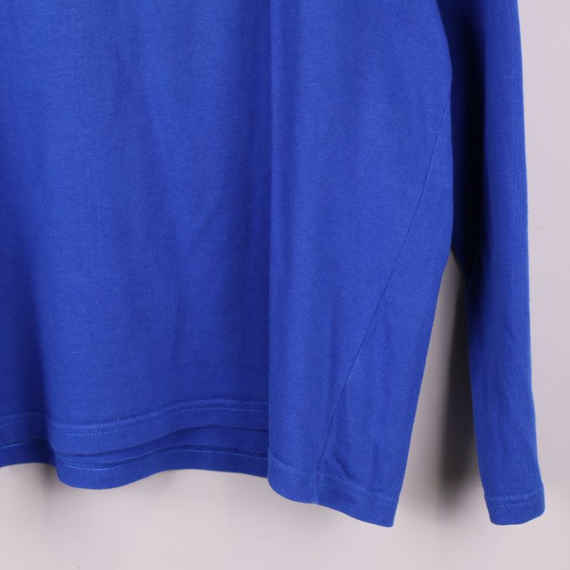 Närbild på nederkant av blå tröja och lång ärm