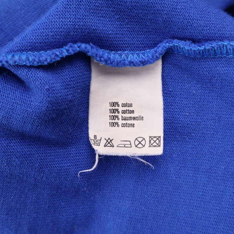 Tvättrådslapp med information om 100% bomull