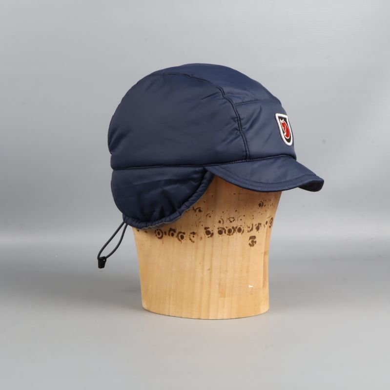 Blå vadderad keps med öronlappar från höger sida