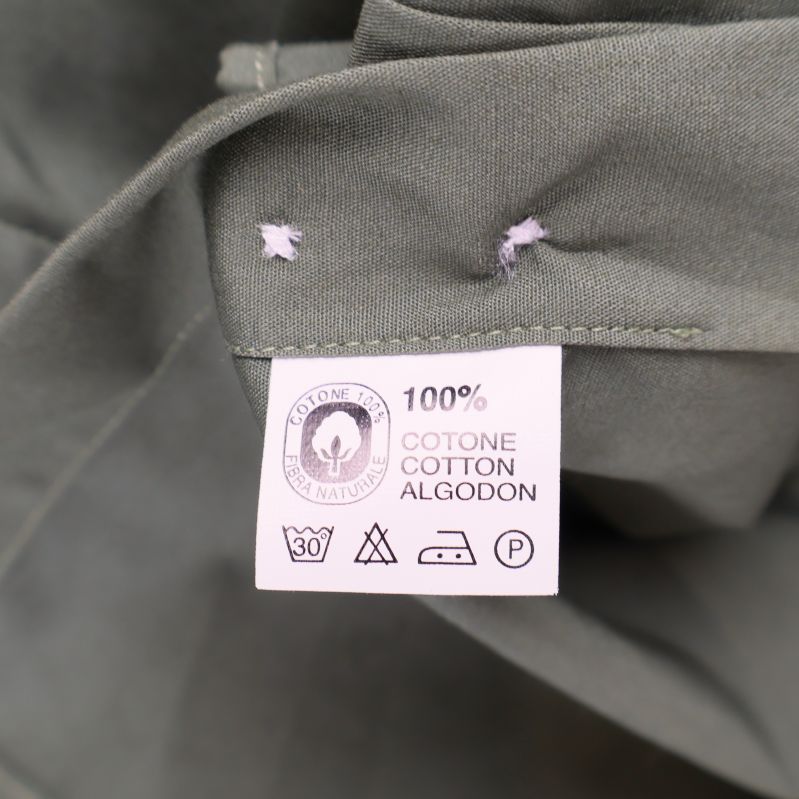 Materialetikett som visar 100% bomull