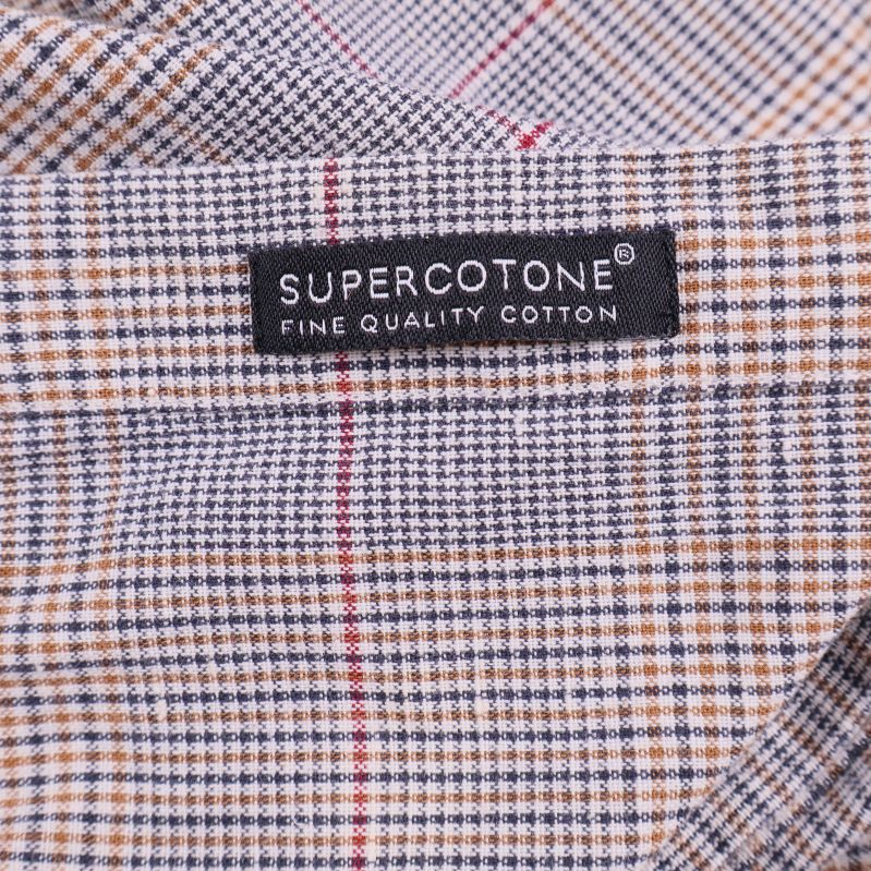 Etikett Supercotone fine quality cotton på rutigt tyg