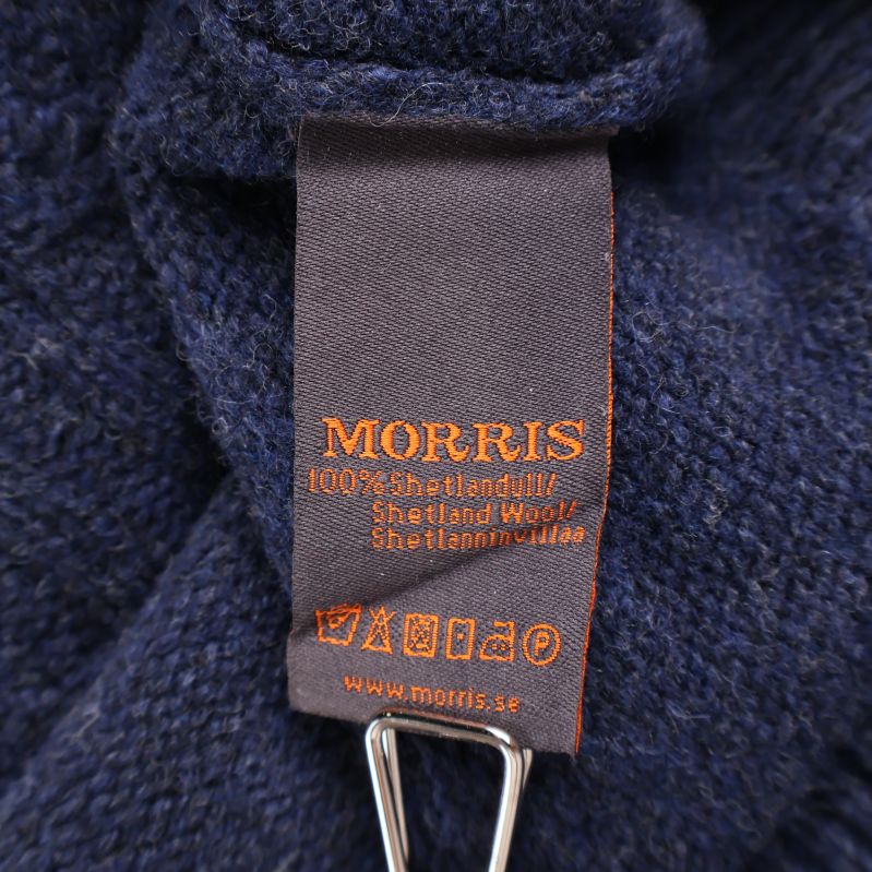 Materialetikett som visar 100% Shetlandsull från Morris