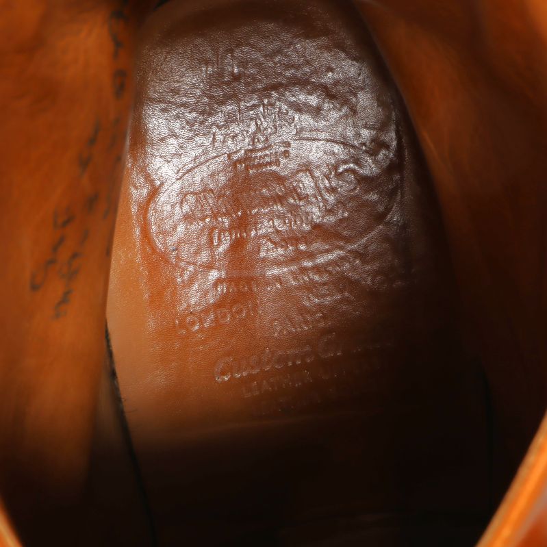 Stämpel på insidan av boots med otydlig text