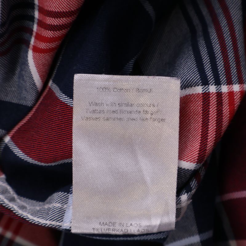 Materialetikett som visar 100% bomull