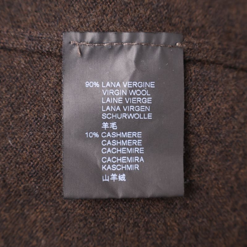 Materialetikett som visar 90 procent ull och 10 procent kashmir